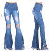 Pair of distressed blue jeans with frayed hem on a white background
